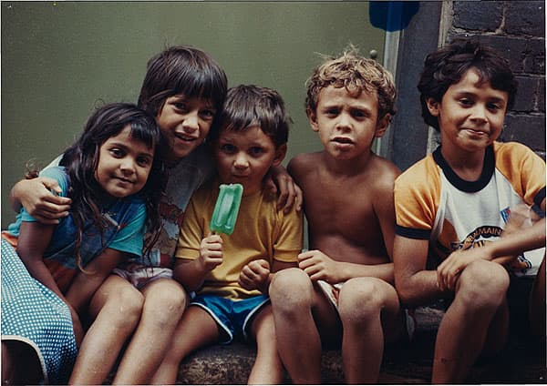 Michael RILEY | The Rileys: Dantoine, Megan, Tabatha, Noel, Douglas and Christopher [five children, one green paddlepop], c. 1983